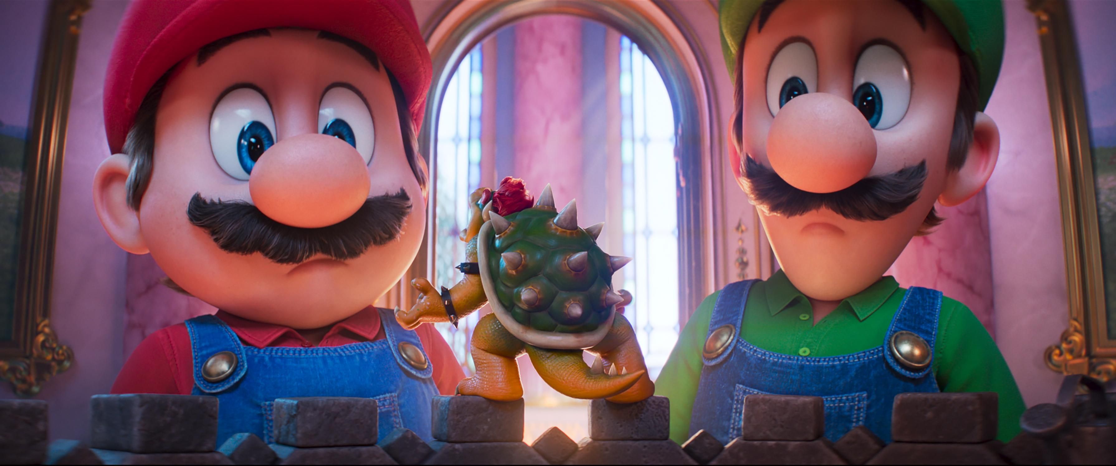 Mario and Luigi look down at miniature Bowser in a still from The Super Mario Galaxy Movie