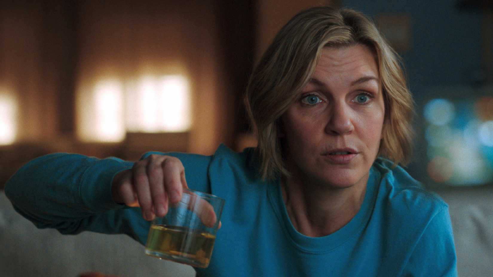 Pluribus protagonist Carol Sturka holds up a glass of yellow, clear liquid, which the show's "pod people" have been drinking nonstop.