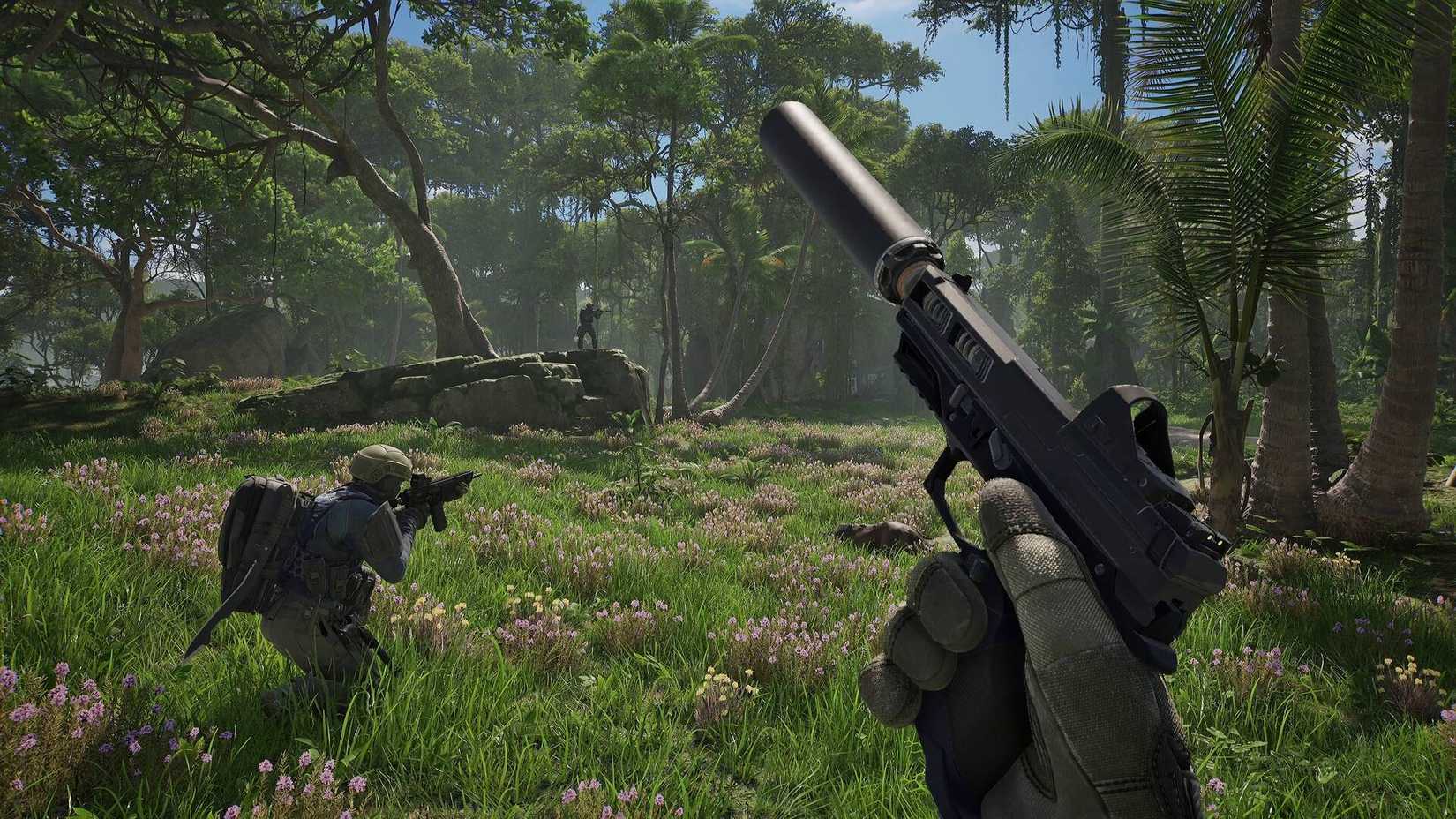 The player in PUBG: Black Budget holding a pistol with a silencer equipped, with another player crouched in front of them aiming down their assault rifle into a jungle.
