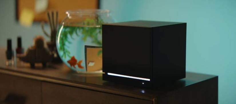 Valve's Steam Machine, placed next to a goldfish tank. 