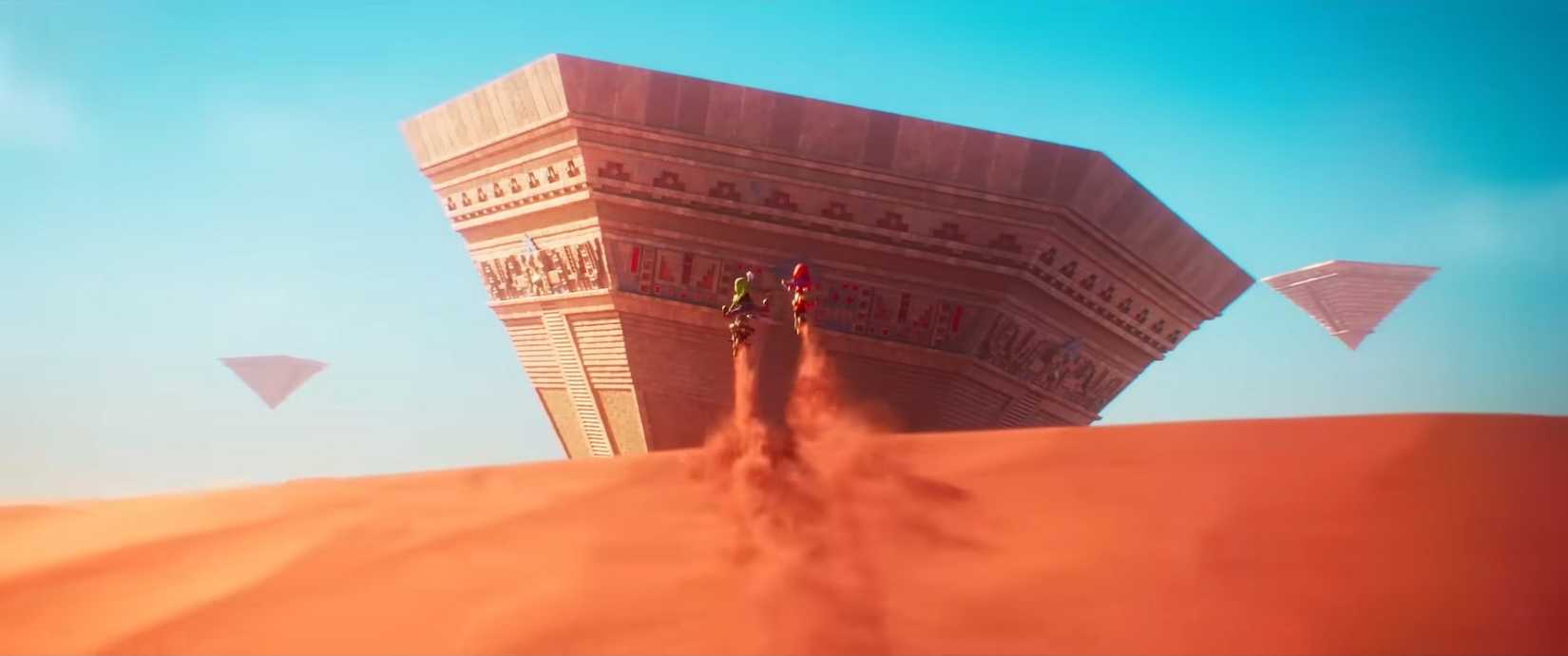 Luigi and Mario launch off a sand dune toward an Inverted Pyramid from the Sand Kingdom in The Super Mario Galaxy Movie trailer 