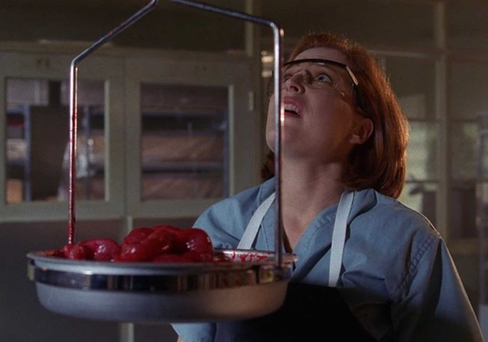 Dana Scully (Gillian Anderson) weighs a pile of organs in The X-Files episode 