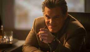 Killian (Josh Brolin) smirks and points across a desk in The Running Man 2025
