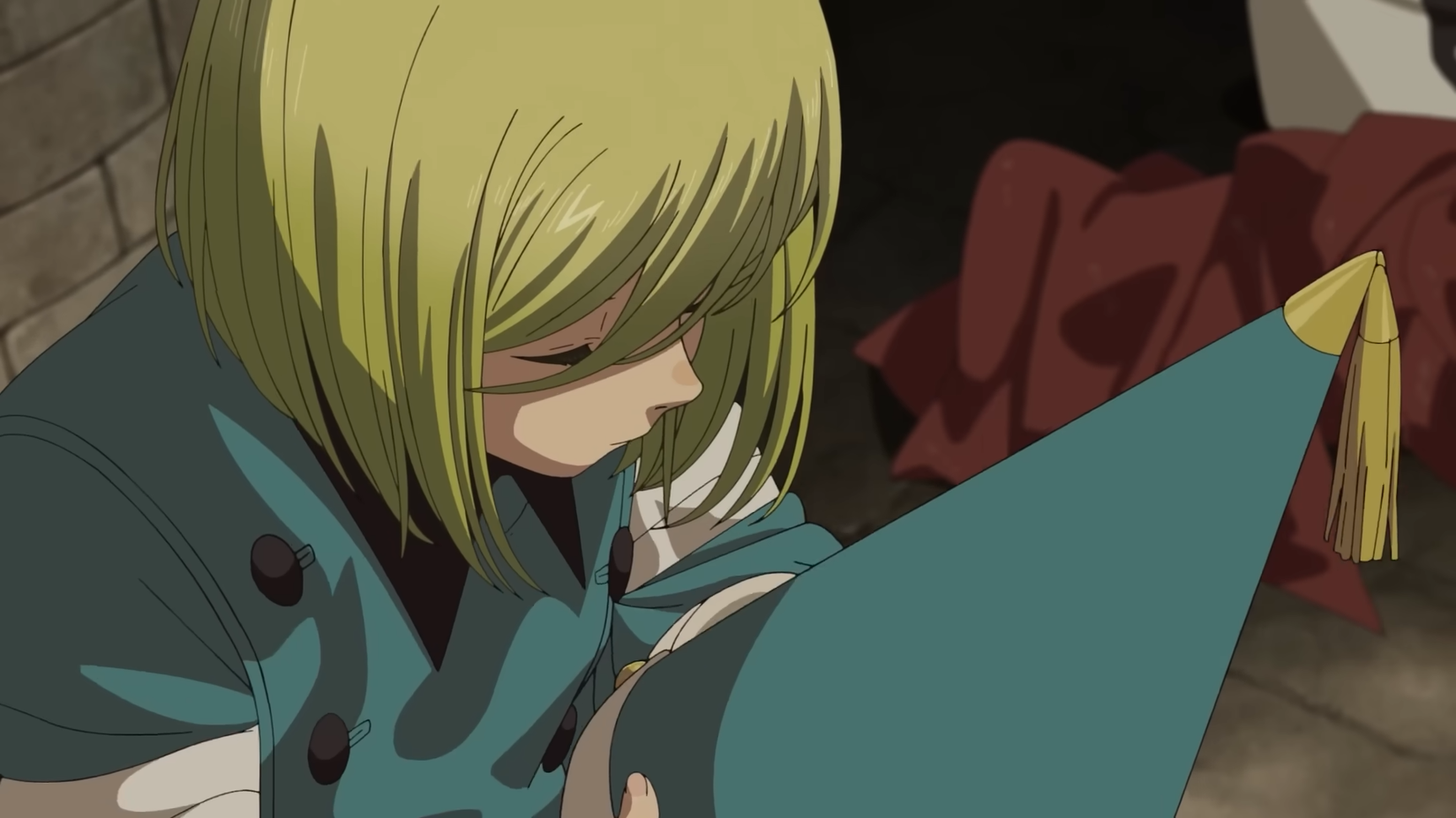 A young blonde witch wearing green holds a pointed witch hat