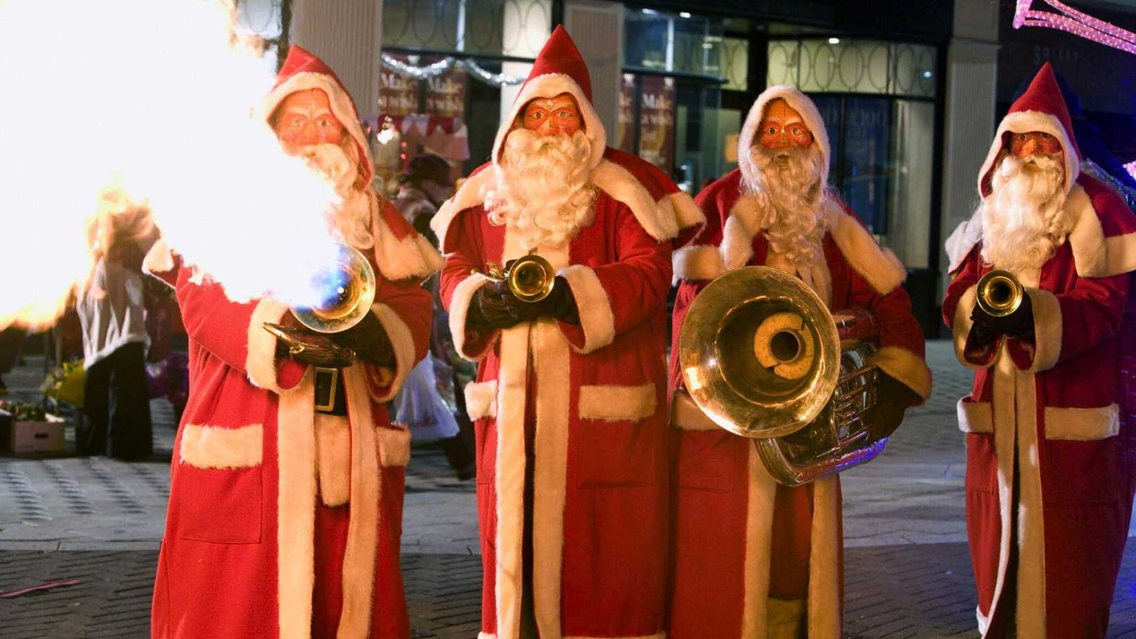 An image from 2005's Doctor Who Christmas special, the Christmas Invasion. It shows four Santa Clauses statues, each with a musical instrument. One breathes fire through a trumpet.