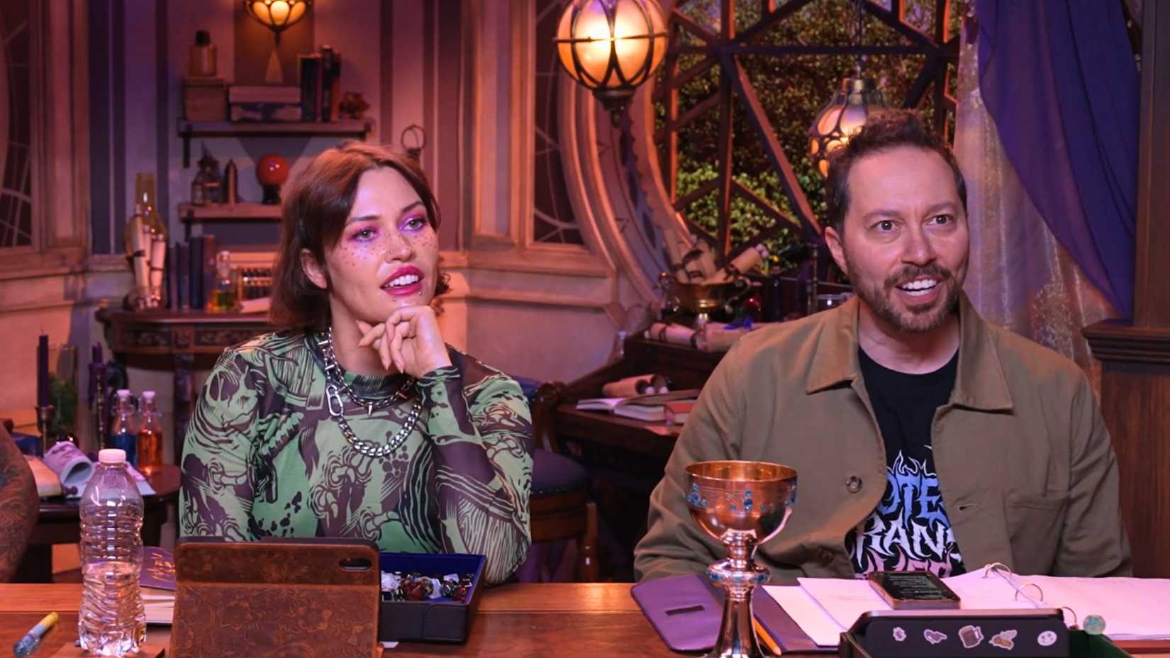 Whitney Moore and Sam Riegel engaged in a discussion during a D&D session.