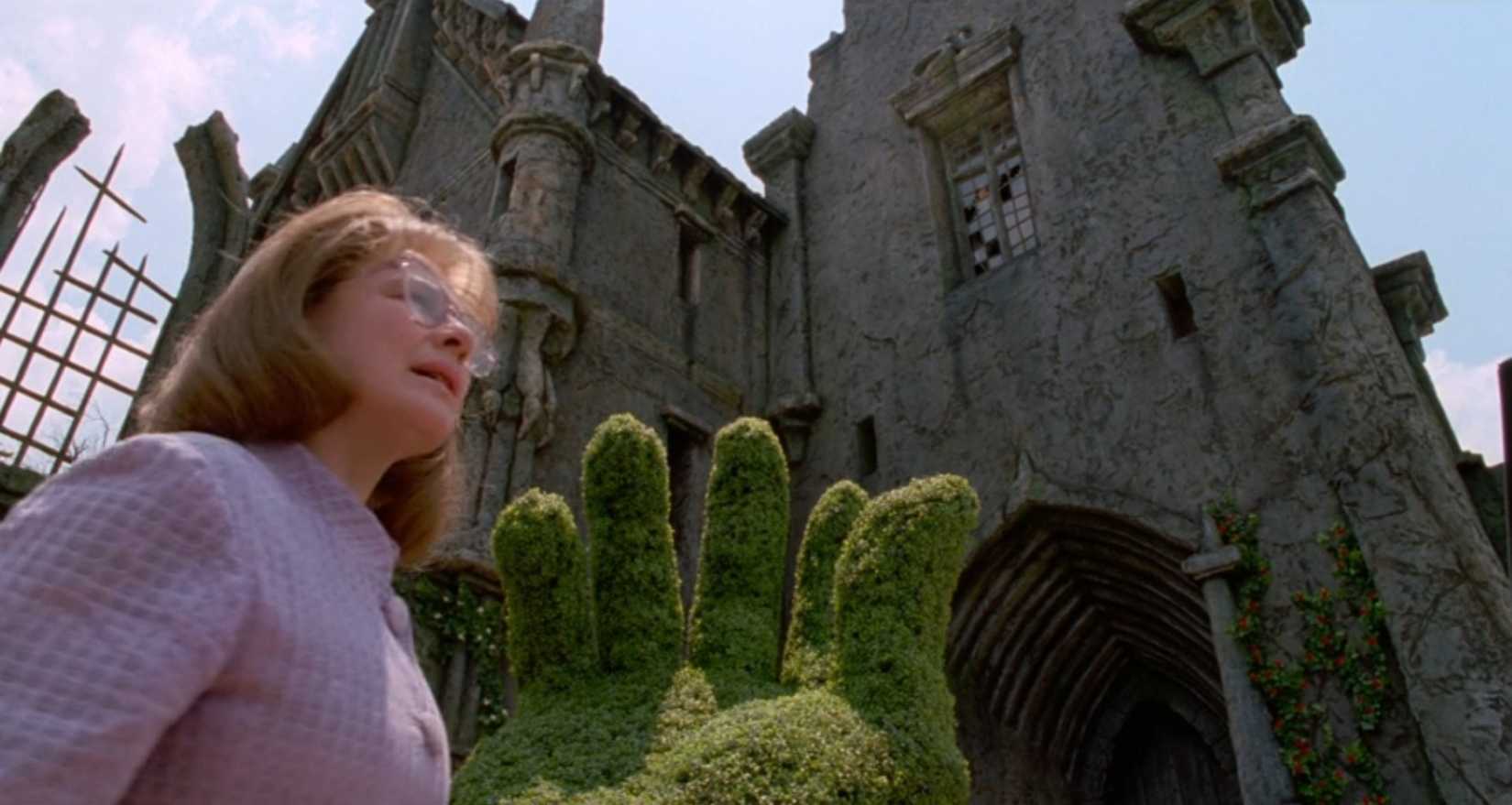 In a scene from Tim Burton's Edward Scissorhands, an Avon-lady (Dianne Wiest) approaches a bizarre gothic castle that overlooks her pastel-colored suburbs. Her outfit is also pastel-colored, bringing that sense of contrast into the scene.