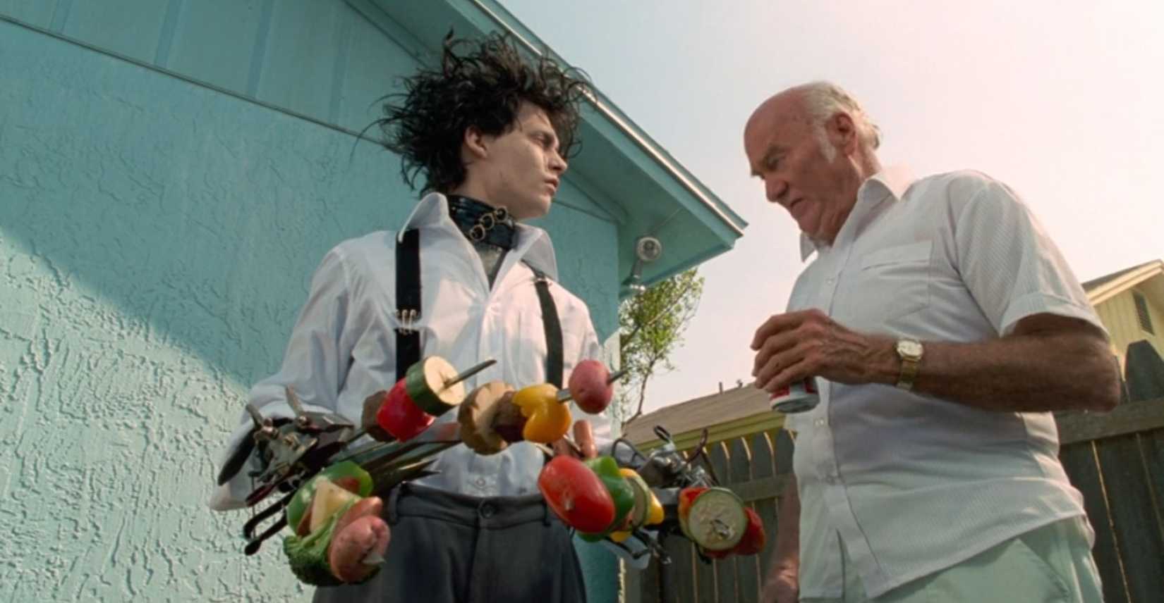 In a scene from Edward Scissorhands, the title character chats with a suburbanite at a barbecue, where Edward has roast meat and vegetables stuck to his scissors.