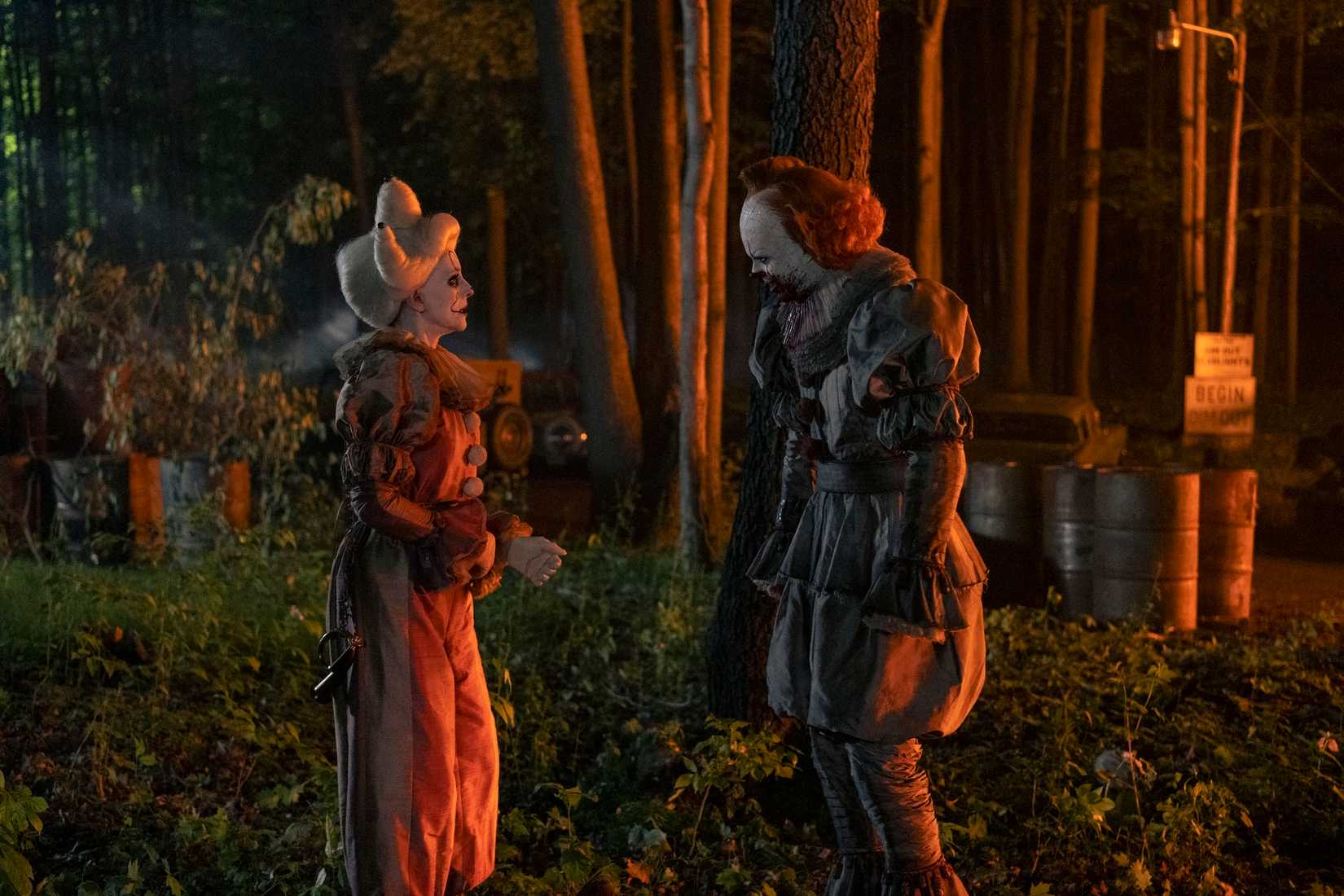 Ingrid (Madeleine Stowe) in her clown costume, approaching Pennywise (Bill Skarsgard), thinking he's her father on Welcome to Derry
