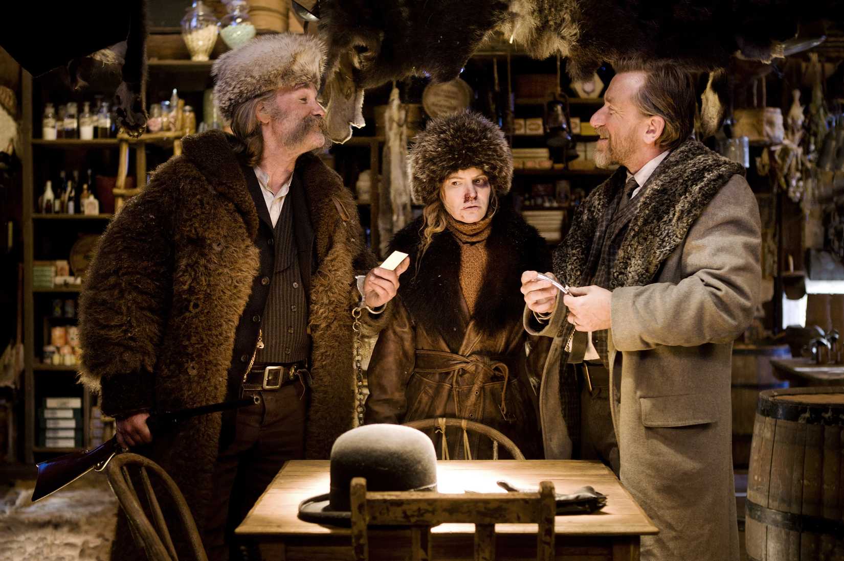 Kurt Russell, Jennifer Jason Leigh, Tim Roth bicker in a log cabin in The Hateful Eight