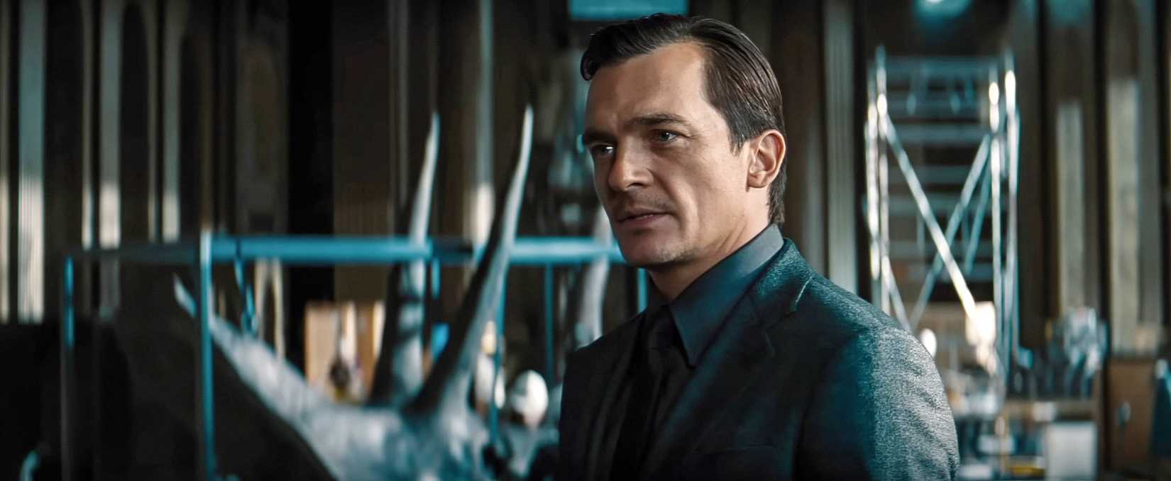 Rupert Friend as Martin Krebs, a well-dressed, sleazy pharma-bro, in Jurassic World Rebirth