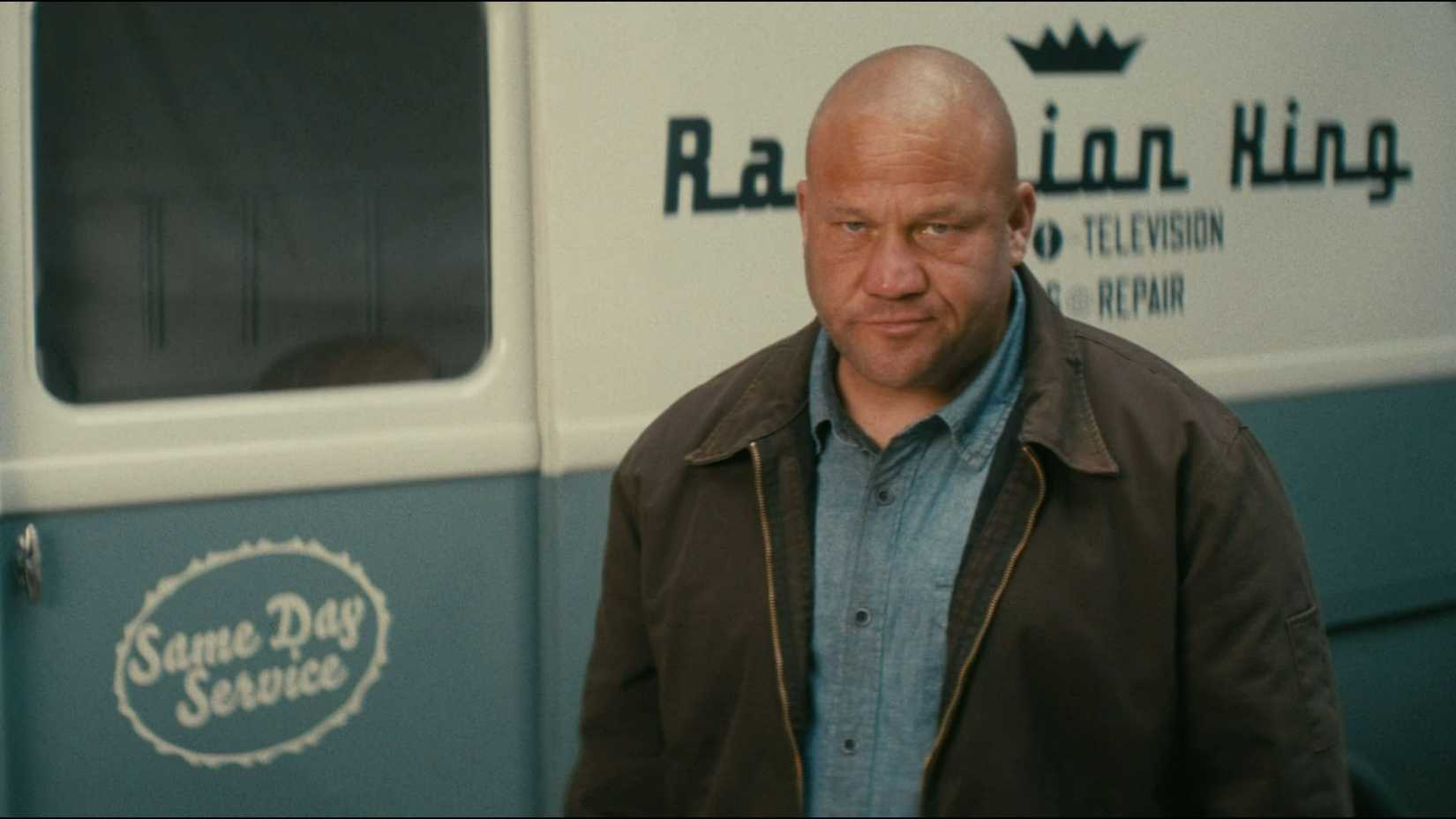 A man stands in front of the Radiation King's van in Fallout Season 2.