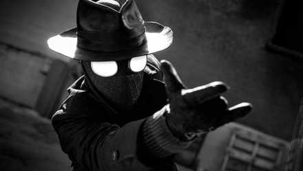 A still of Spider-Man Noir aiming his web shooters from the live-action Spider-Noir series