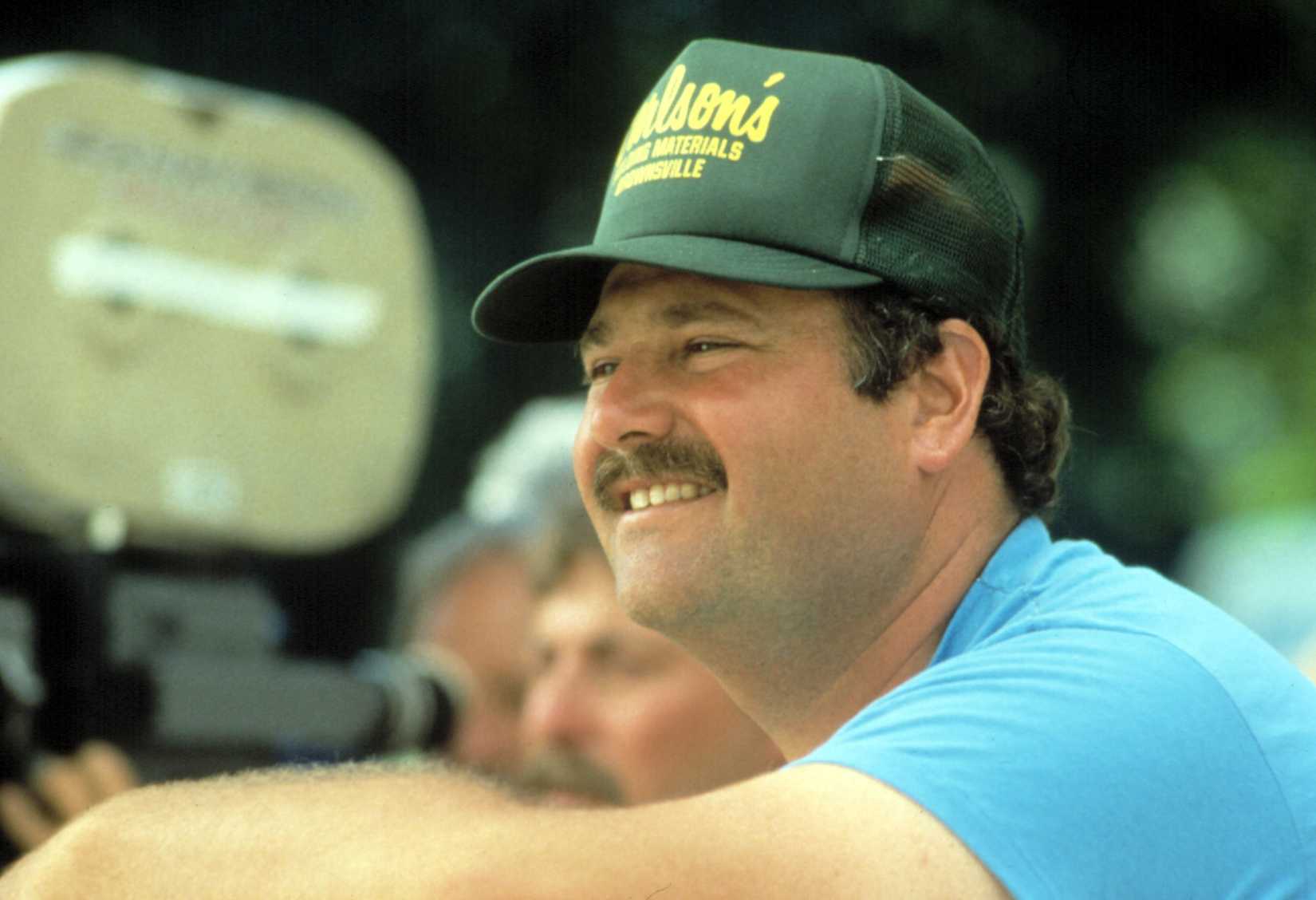 Rob Reiner in a trucker cap directing Stand by Me in 1985.