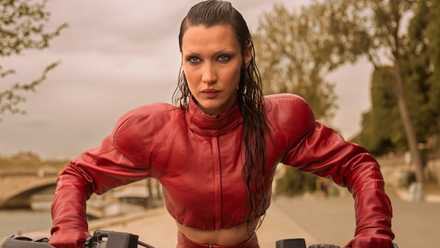 An image from The Beauty. It shows a seriously sweaty model decked out in red leather, riding a motorbike.