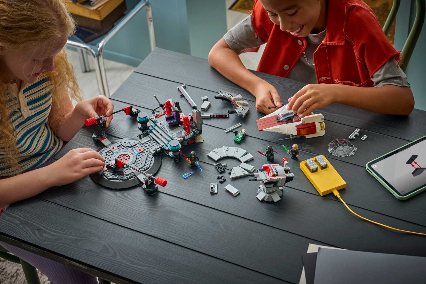Two children working together to build the Lego Smart Play Star Wars Throne Room set