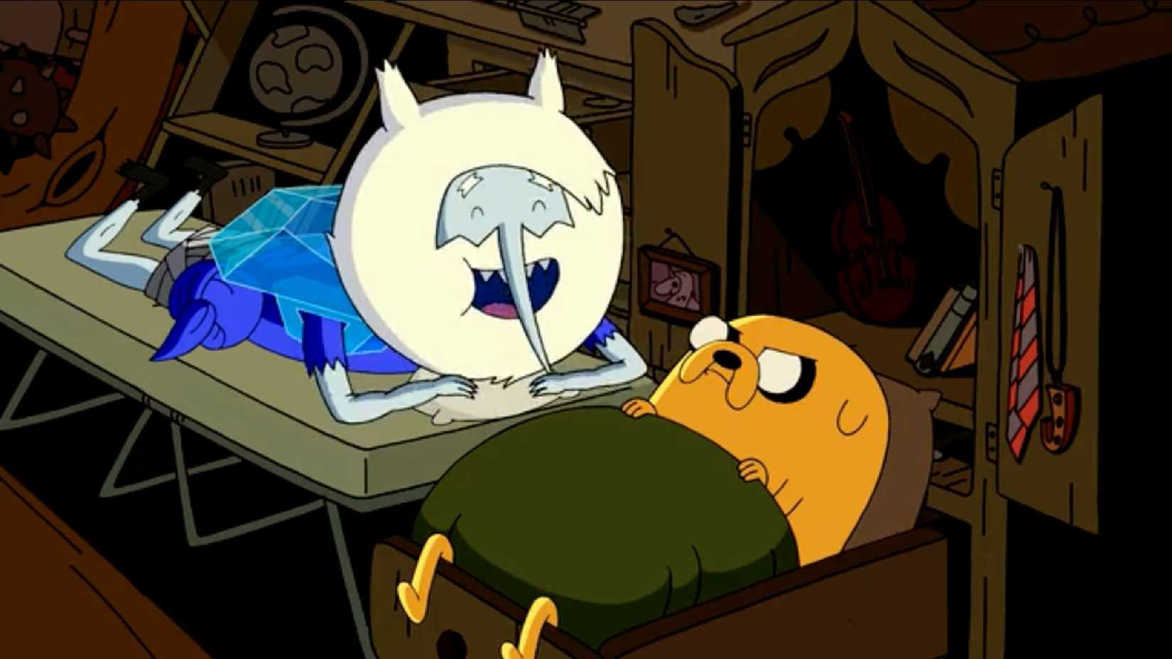 Adventure Time's Ice King talking to Jake who looks mad