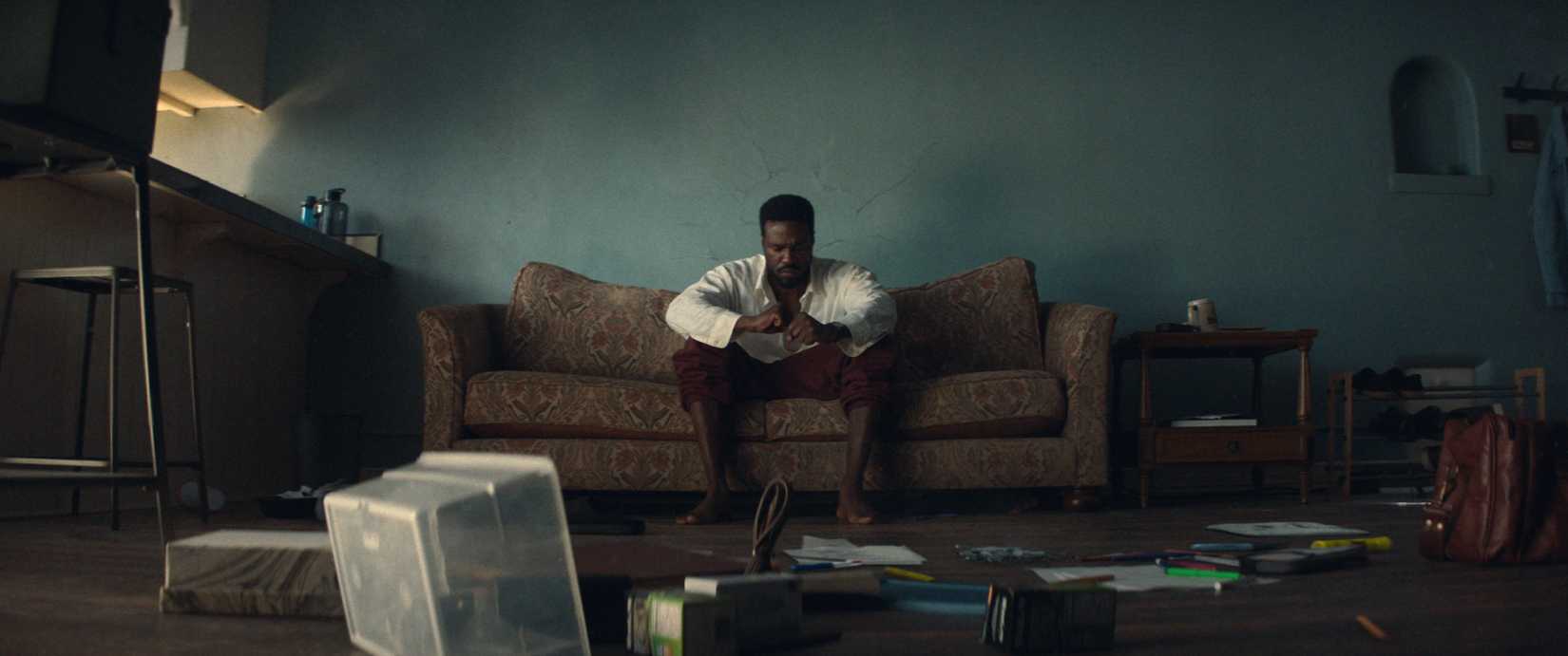 Simon Williams (Yahya Abdul-Mateen II) sits alone on his couch in his dingy Los Angeles apartment in Wonder Man