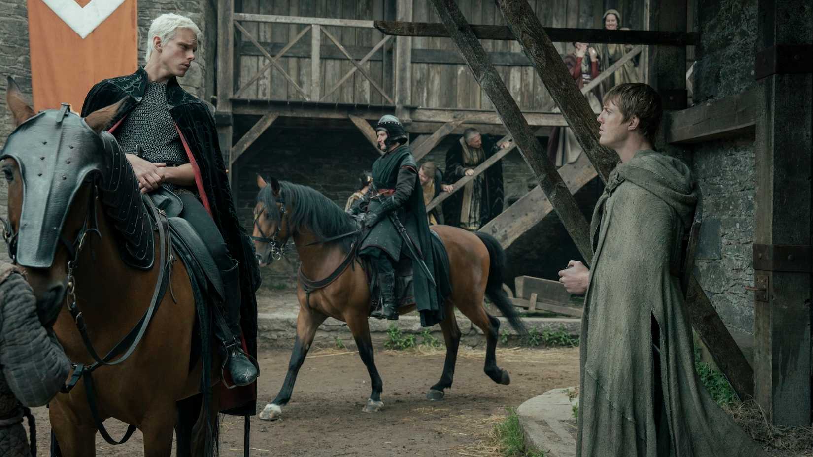 Prince Aerion Targaryen (Finn Bennett) sits atop a horse looking down at the hedge knight Dunk (Peter Claffey) in A Knight of the Seven Kingdoms