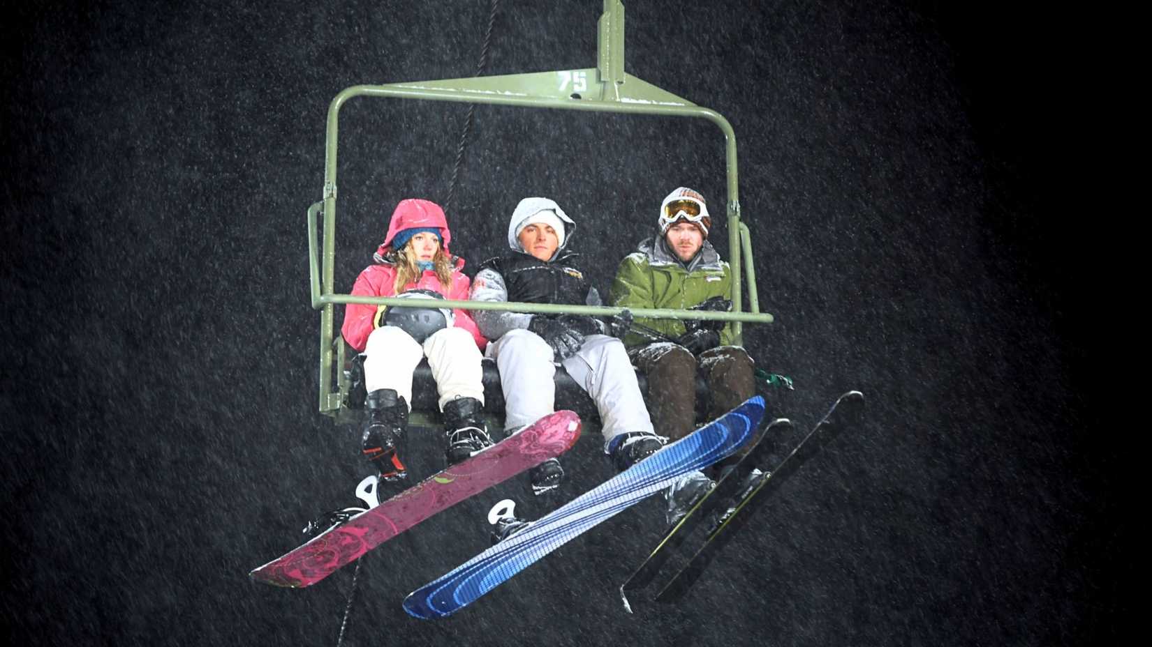 An image from Frozen 2010. It shows three individuals on a green ski lift.