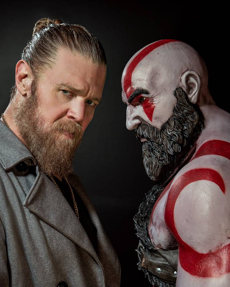 Actor Ryan Hurst alongside a Kratos statue