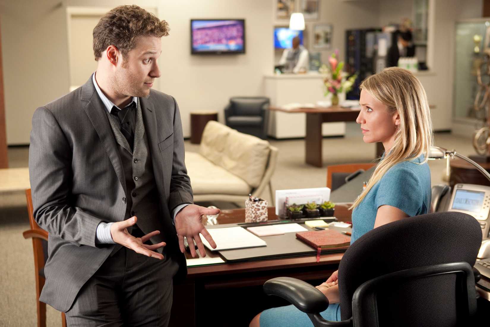 Seth Rogen and Cameron Diaz chat in a newsroom setting of their film The Green Hornet, where Rogen plays a newspaper owner and Diaz, sadly, his secretary.