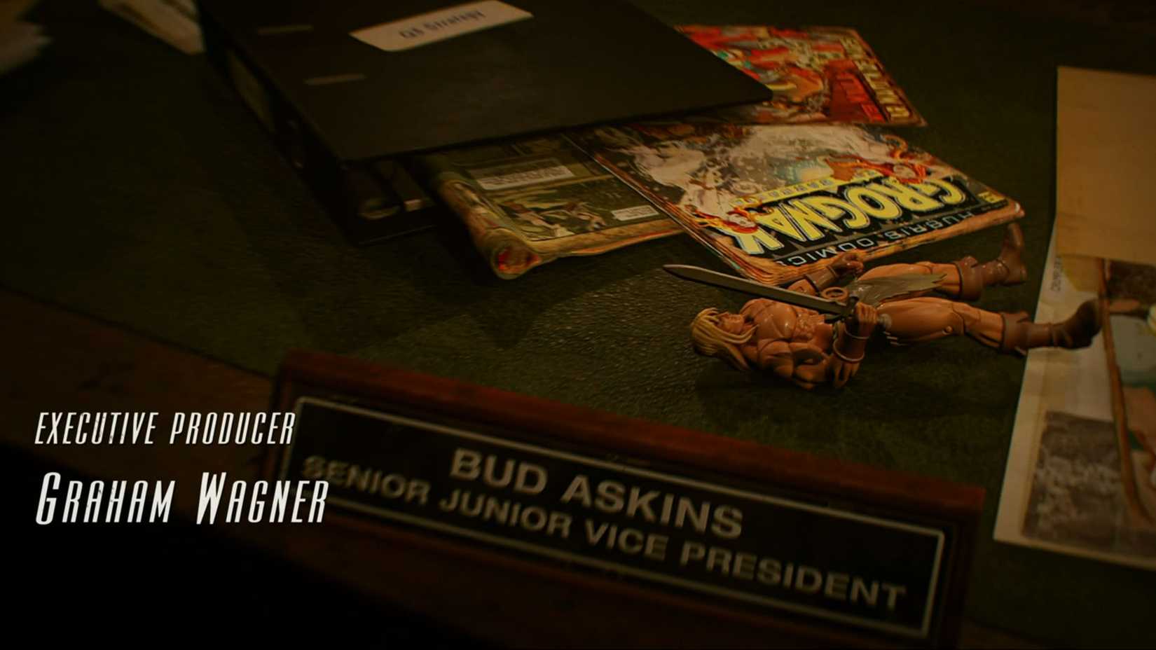 Bud Askins' desk featuring Grognak the Barbarian comics and action figure.