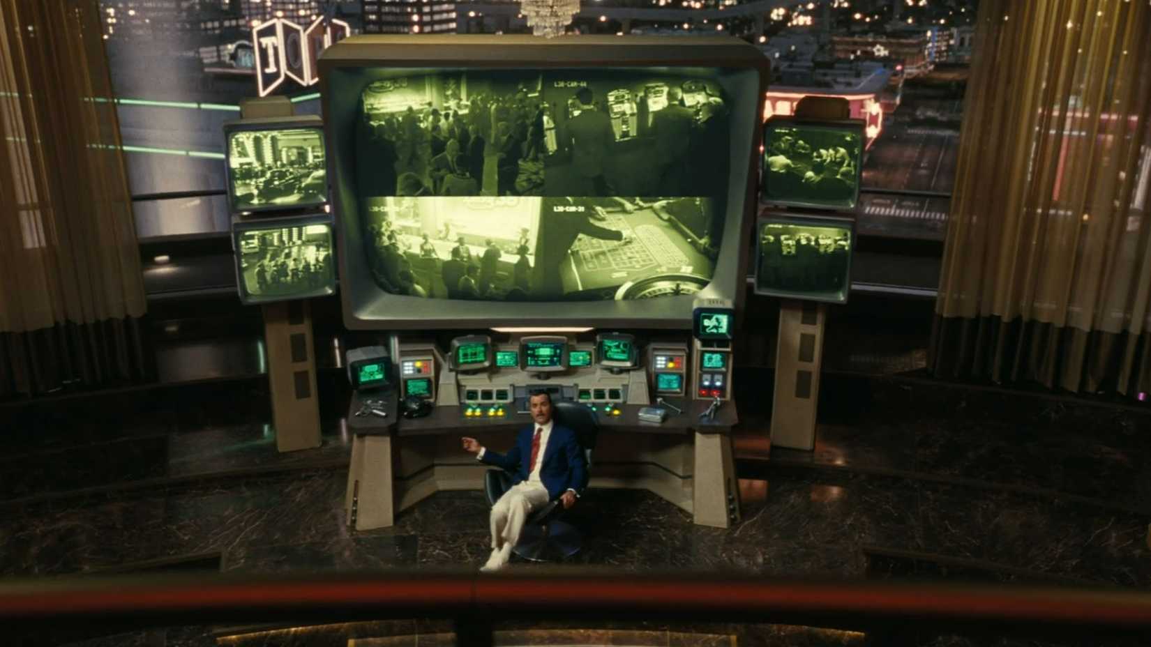 Mr. House sitting in front of his array of monitors in the Fallout TV show.