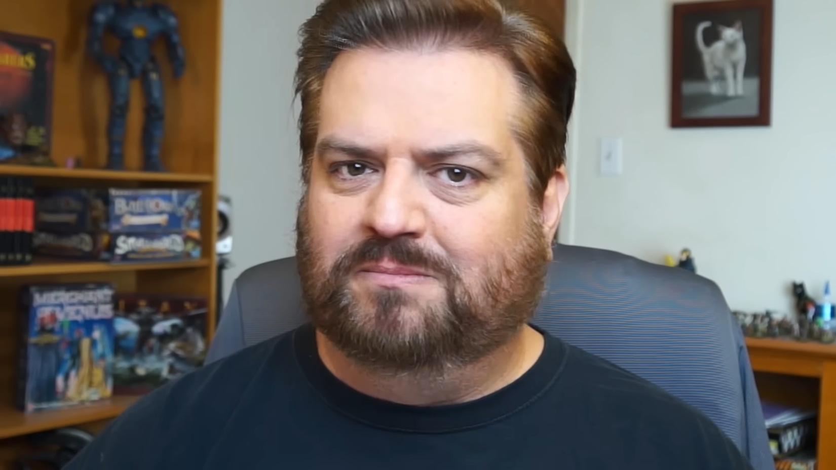 A man with a beard looking directly at the camera