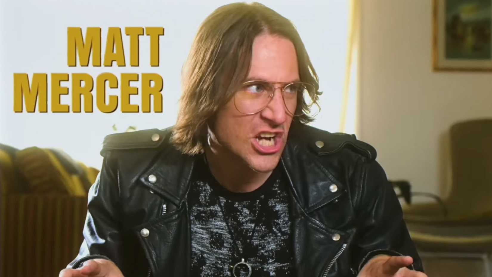 An image from Critical Role's Campaign 2 opening from Geek & Sundry. It shows Matthew Mercer dressed in leather, donning glasses and pulling a face.