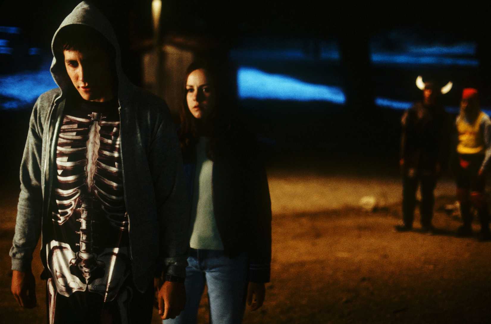Jake Gyllenhaal, wearing a hoodie over a skeleton onesie, and Jena Malone in Donnie Darko