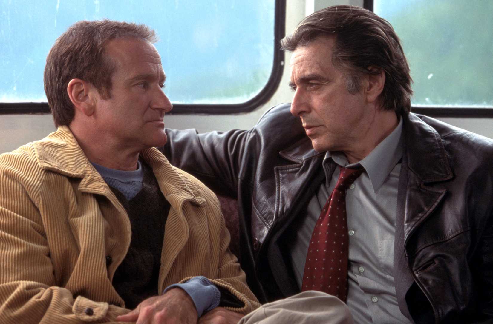 Al Pacino and Robin Williams sit uncomfortably close and look confrontational in a scene from Christopher Nolan's 2002 movie Insomnia