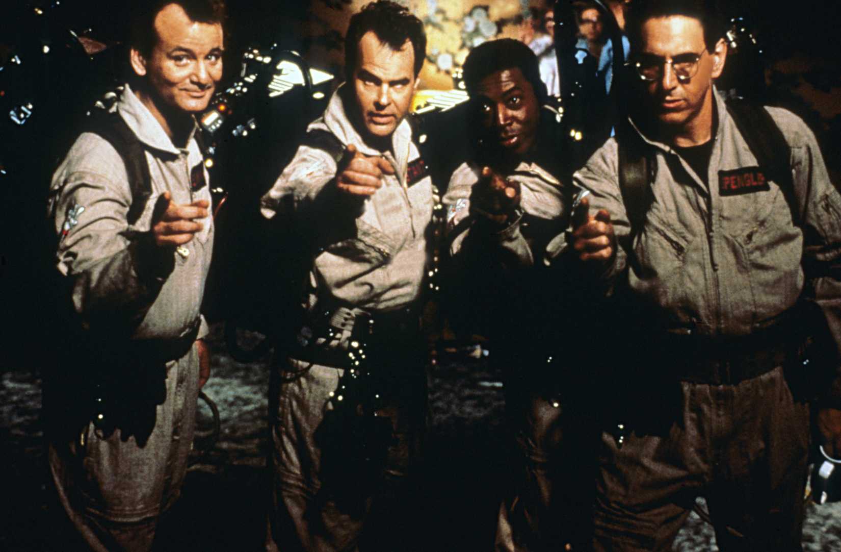 The four stars of Ghostbusters post and point at the camera