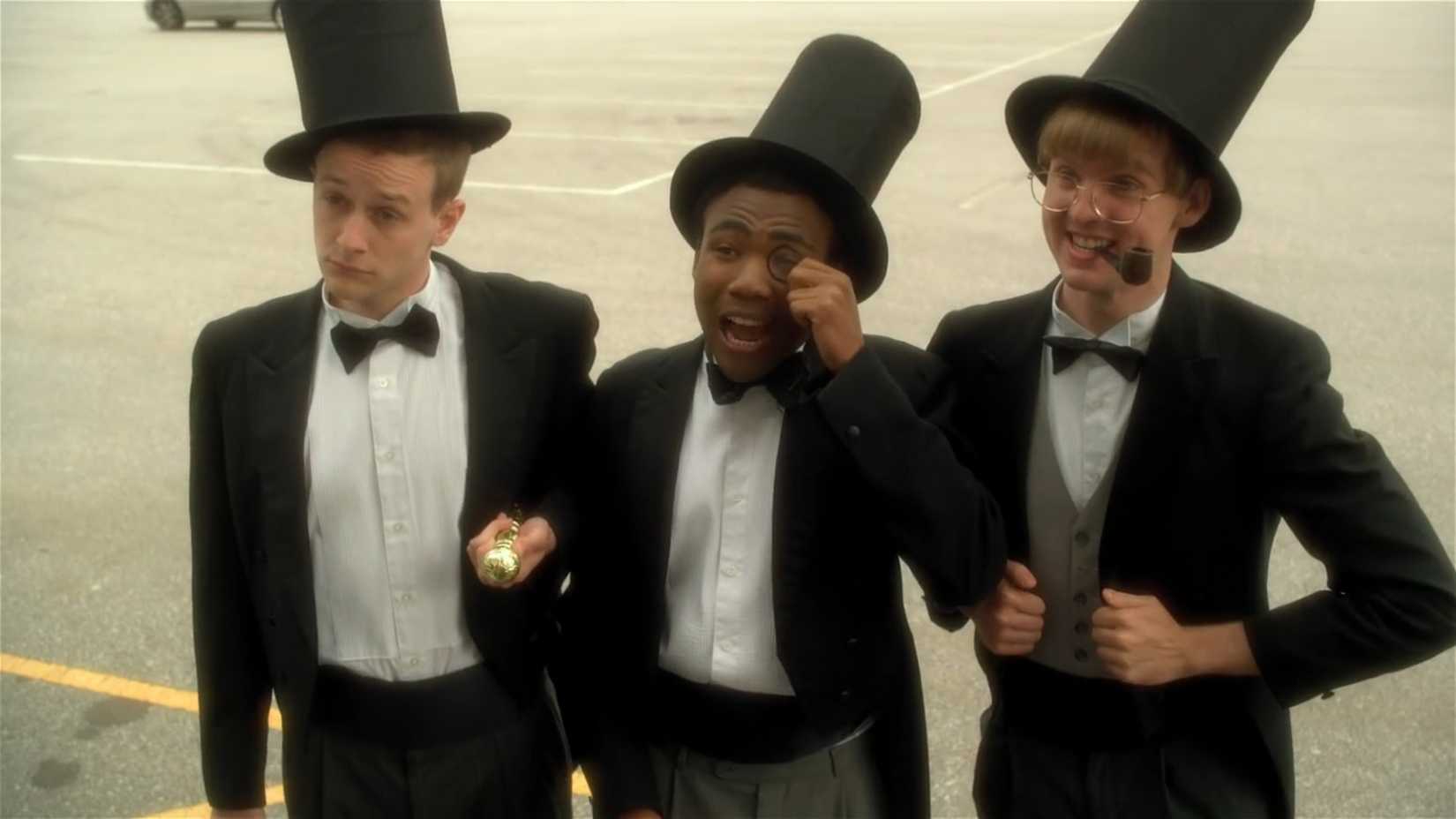 Three very enthusiastic and dimwitted teenage boys dress up in tuxedos, trying to look like rich adults so they can be admitted to a "gentleman's club" in a scene from Mystery Team (2009).