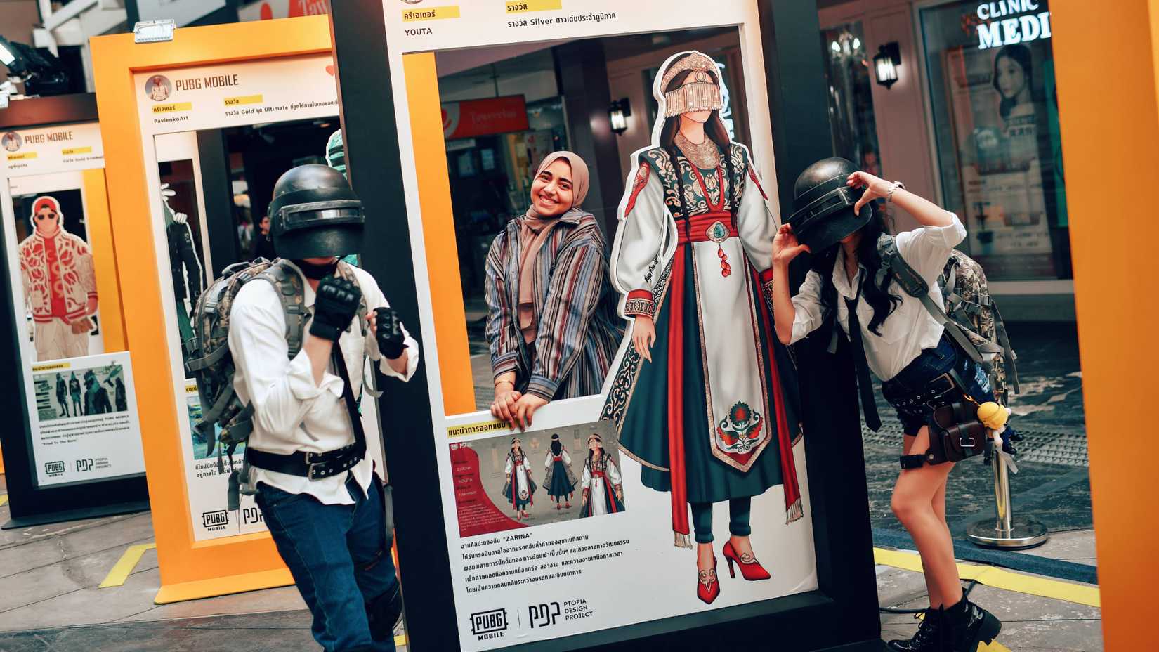 cosplaying pubg mobile creators posing with props.