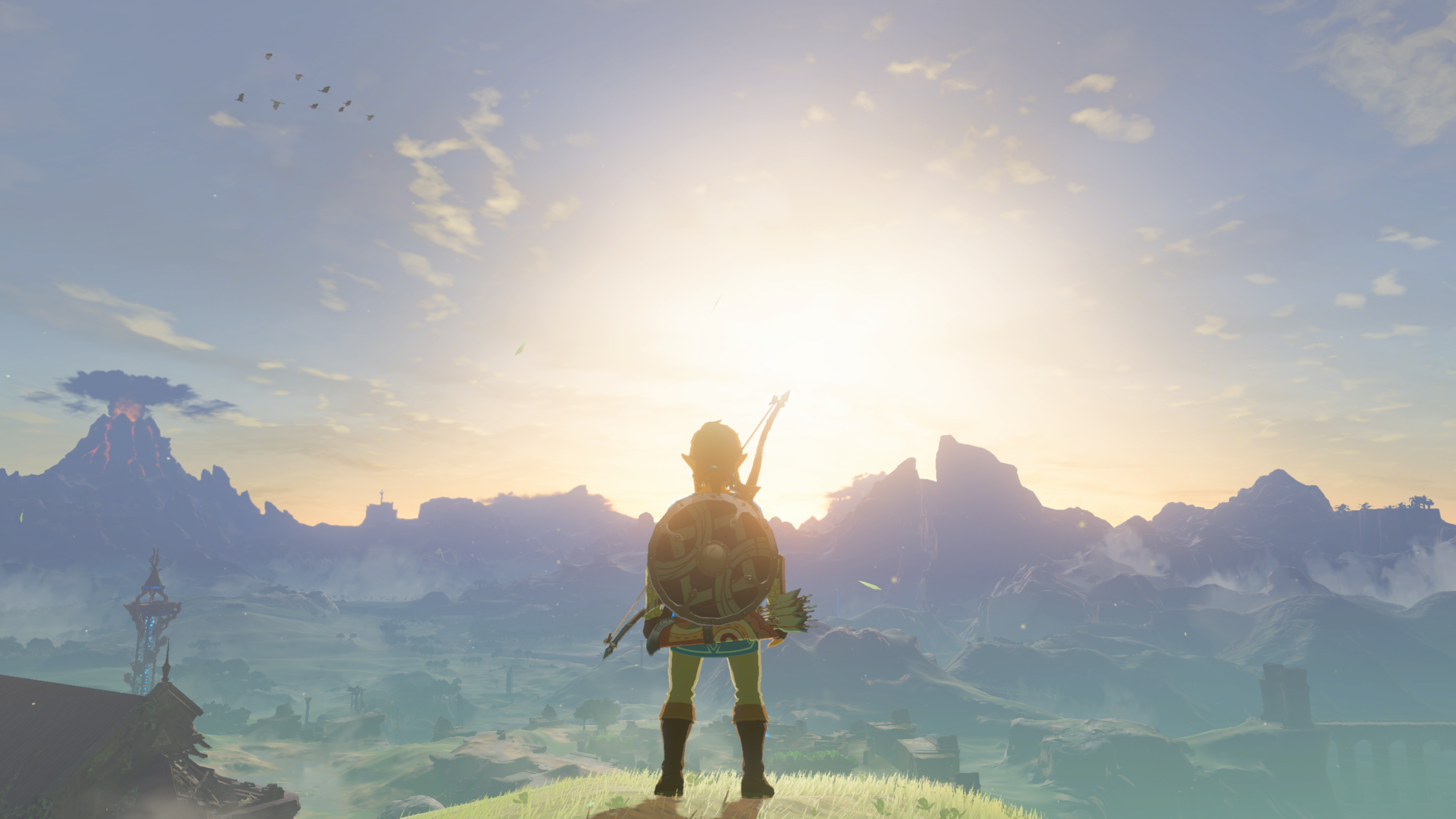 Link stands on the Great Plateau and surveys the Hyrule landscape in Zelda: Breath of the Wild