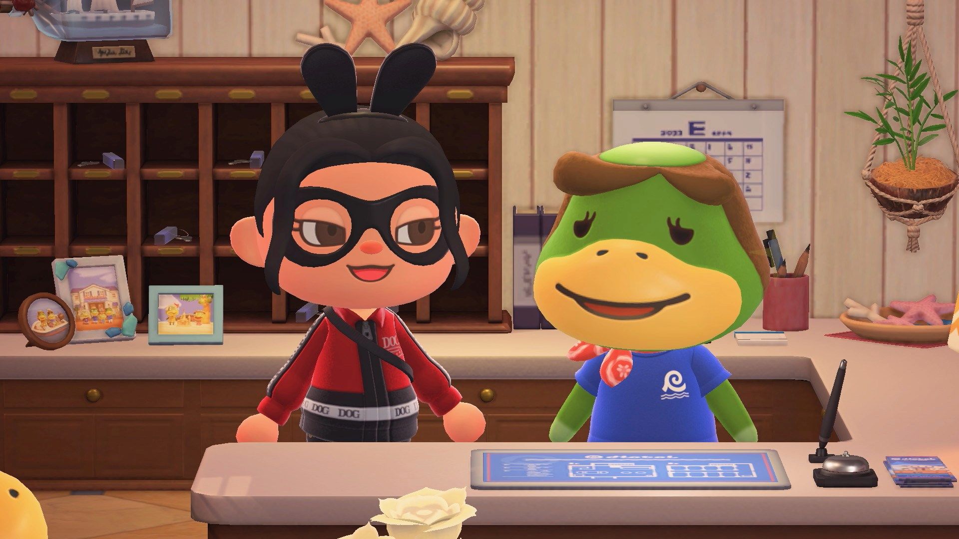 A smirking ACNH character standing next to a female kappa behind a hotel desk.