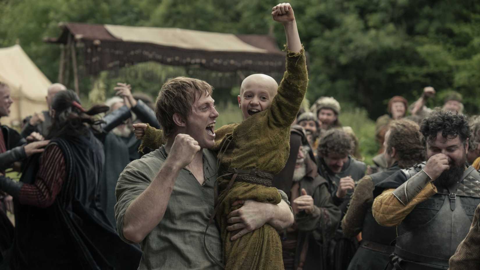 Dunk (Peter Claffey) holding Egg (Dexter Sol Ansell) as they cheer in A Knight of the Seven Kingdoms