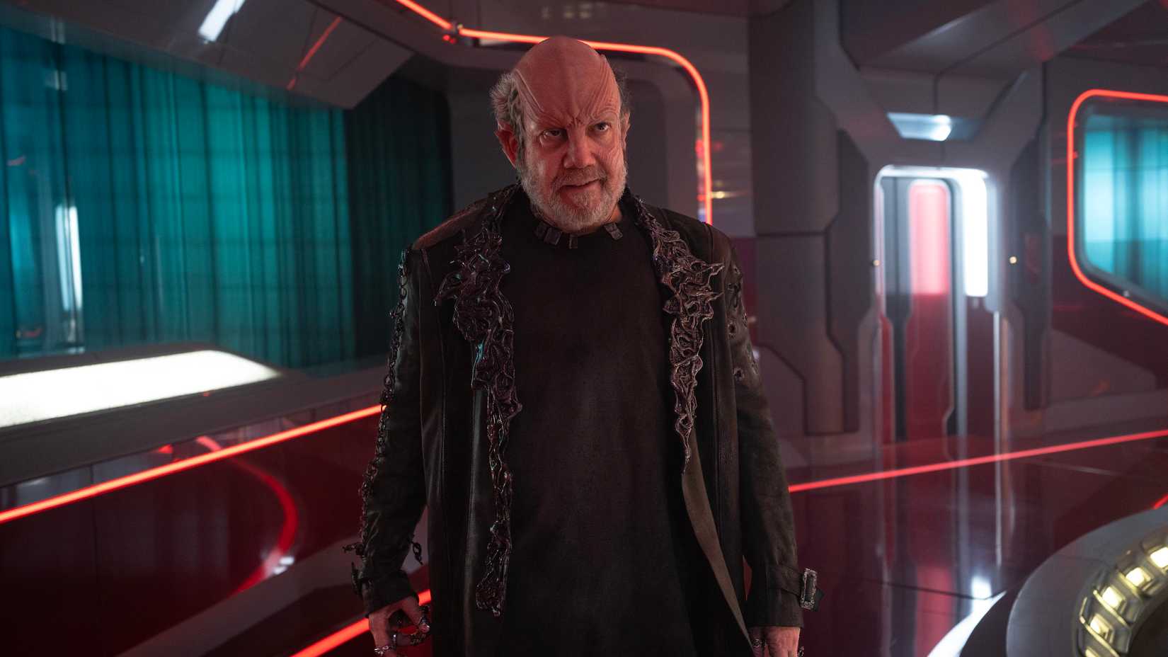 Nus Braka (Paul Giamatti) stands in a corridor of the USS Athena in Starfleet Academy