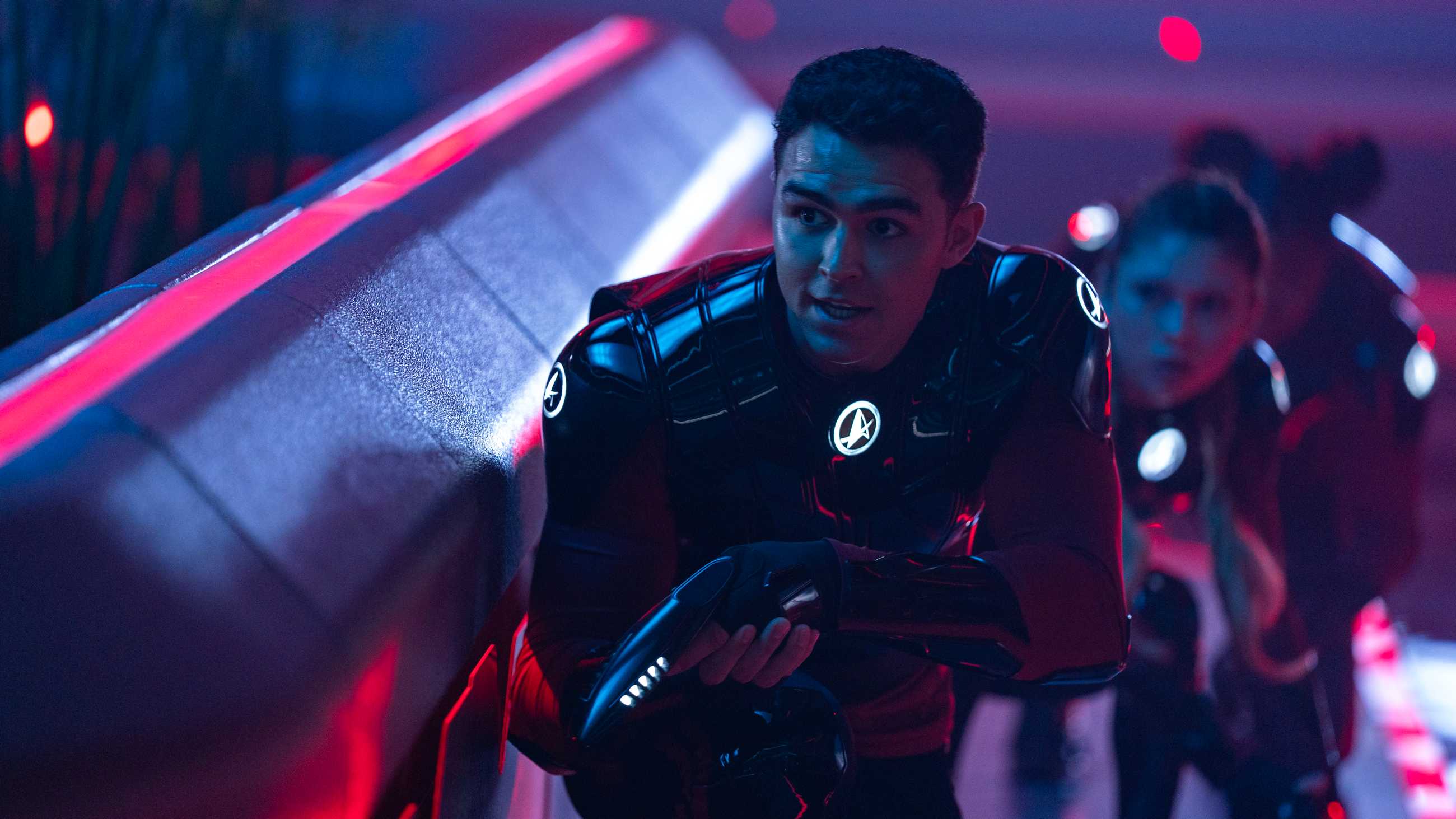 Darem Reymi (George Hawkins), Genesis Lythe (Bella Shepard) and Sam (Kerrice Brooks) play laser tag in Starfleet Academy.