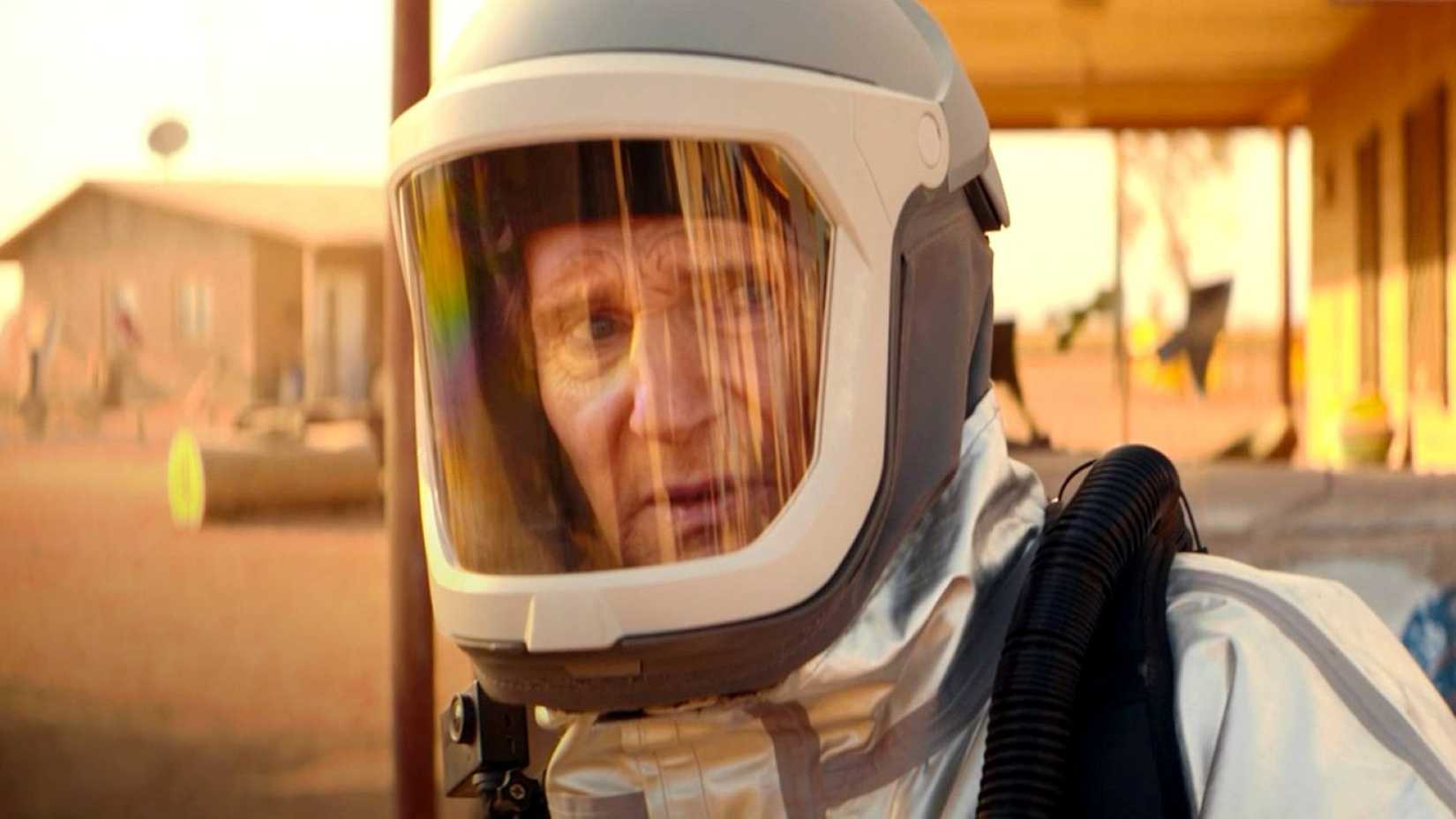 Liam Neeson as Robert Quinn looks on intensely while clad in specialized protective gear in Cold Storage.