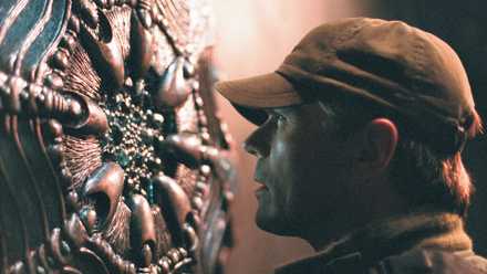 Jack O'Neill inspects an extraterrestrial contraption in Stargate SG-1