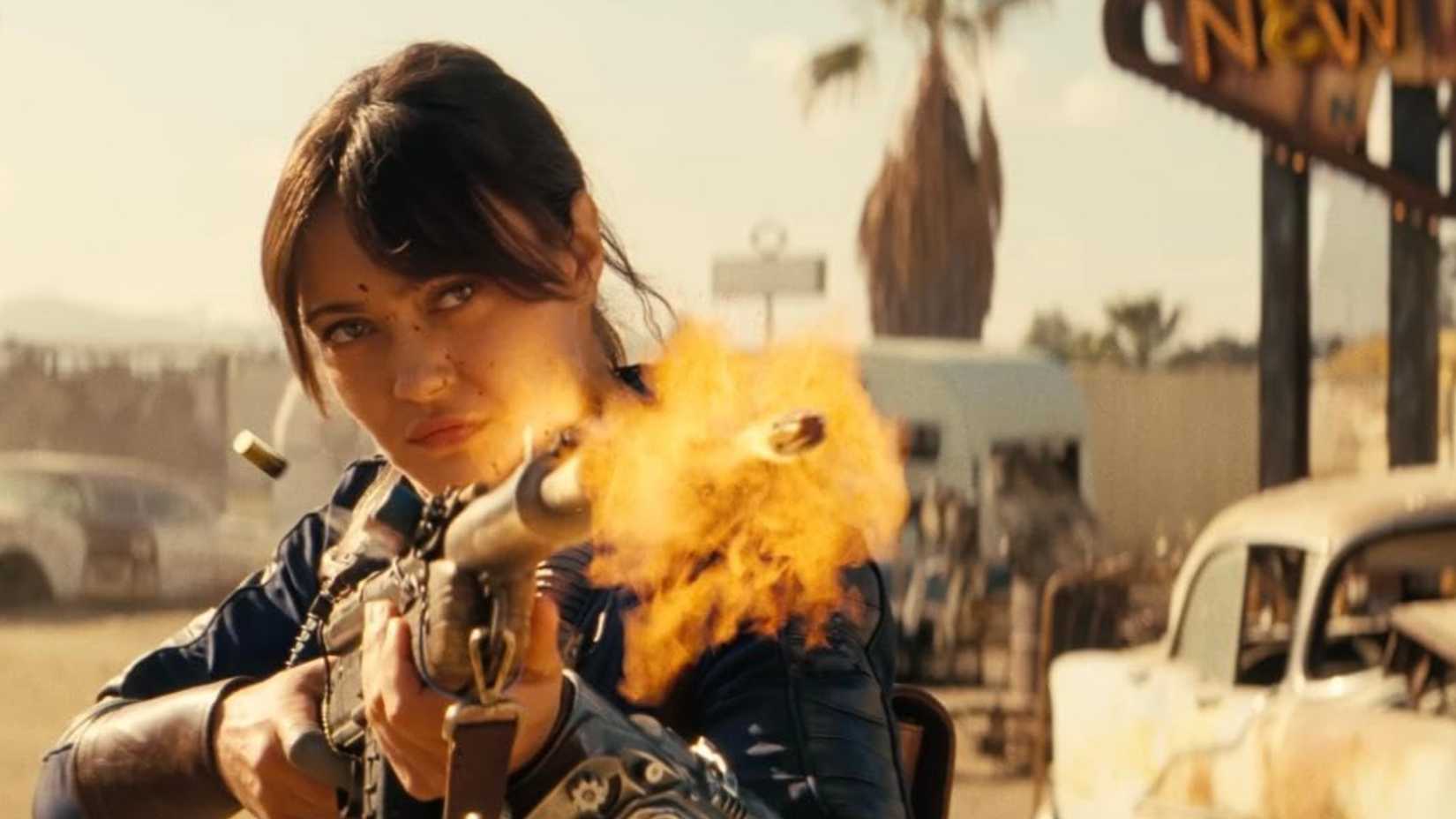A close-up shot of Lucy firing a rifle in a slo-mo scene in Fallout.