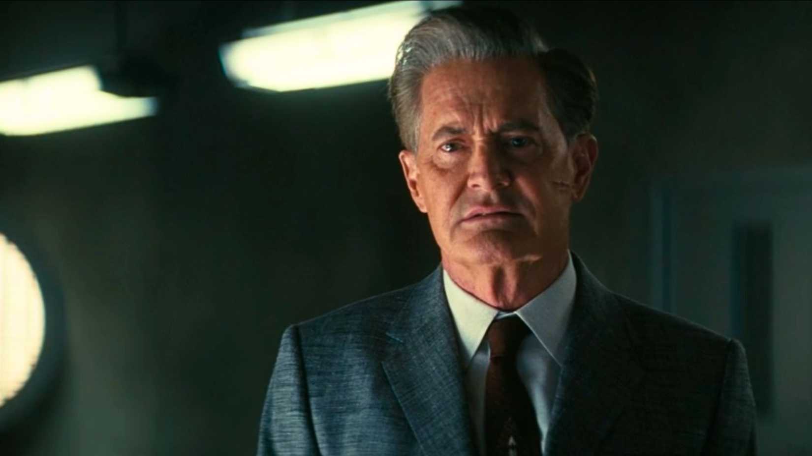 Kyle MacLachlan as Hank MacLean in Fallout season 2. He wears a prim, grey suit and a red tie. He looks a tad sad.