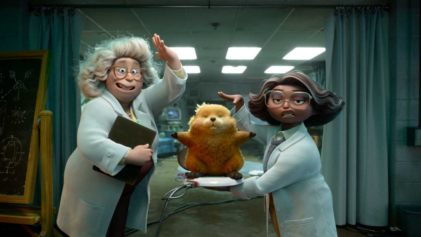 Dr. Sam, a woman with frizzy white hair, and Nisha, a woman with short graying brown hair, both are wearing white labcoats and glasses and showing off a robot beaver on a charging plate in Hoppers 