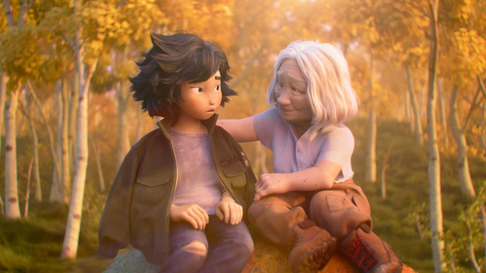 An old woman wearing cargo pants puts her khaki jacket on the shoulders of her granddaughter, Mabel, while sitting on a rock in the woods in Hoppers