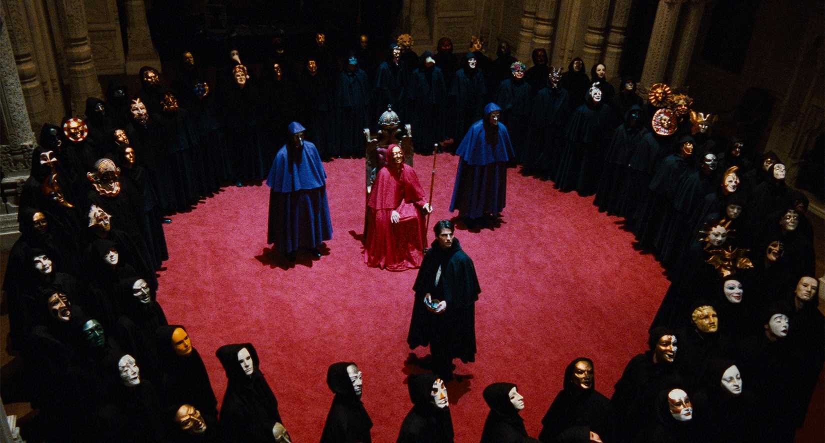 Bill (Tom Cruise) surrounded by masked figures in the ritual scene from Eyes Wide Shut