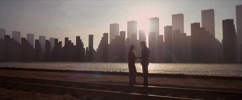 Dom and Mal standing on a dreamworld skyline