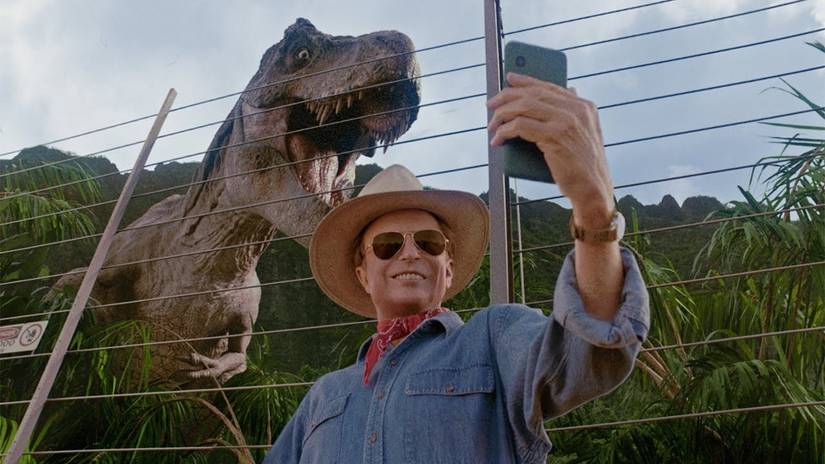 Dr. Alan Grant takes a selfie with a T-Rex in Jurassic Park as part of an Xfinity Super Bowl commercial