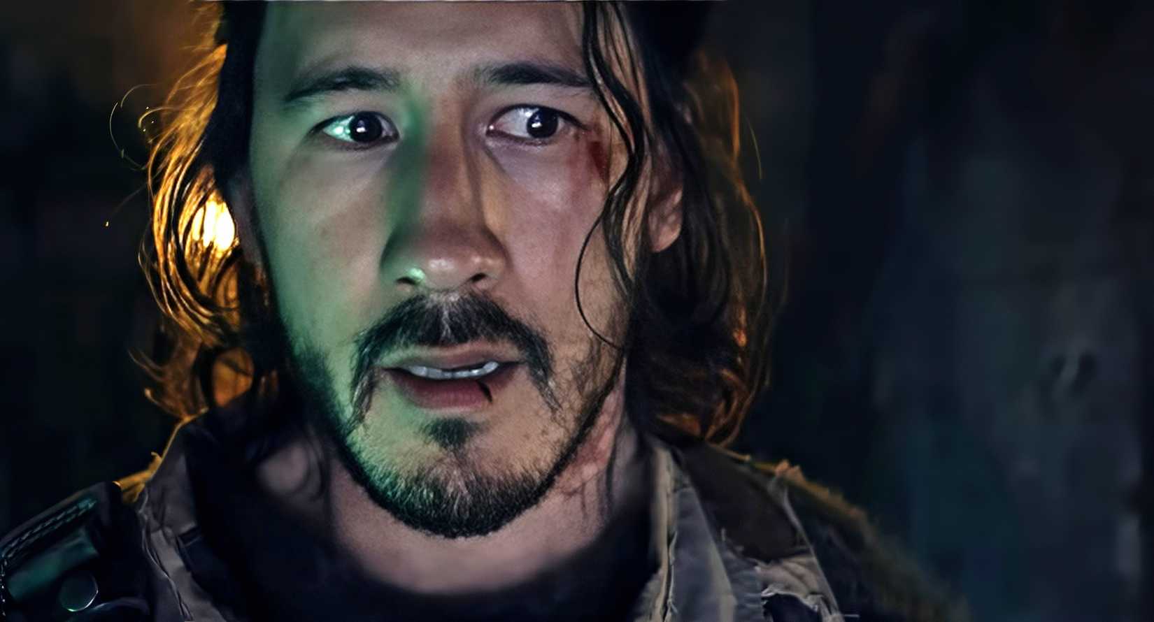 Simon (Mark Fischbach), a sweaty, grimy man with a livid, bloody bruise near one eye, looks frightened in Iron Lung